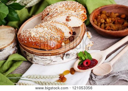 puff with raisins and powdered sugar on a birch saw cut in Russian still life