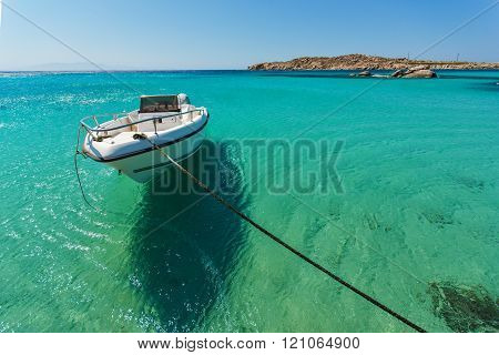 Small boat in Paranga Beach on the island of Mykonos, Greece