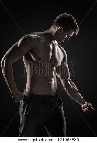 Strong man showing perfect abs, houlders, biceps, triceps and chest