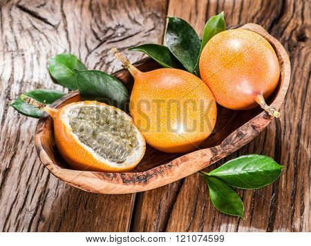 Granadilla fruits on the wooden table.