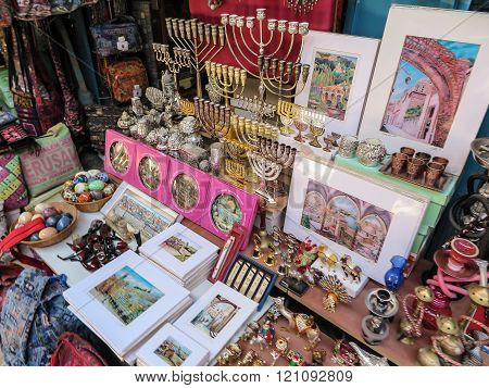 JERUSALEM ISRAEL - JULY 13 2015: Narrow stone street among stalls with traditional souvenirs and goods at bazaar in Old City - popular place among tourists and pilgrims visiting Jerusalem.