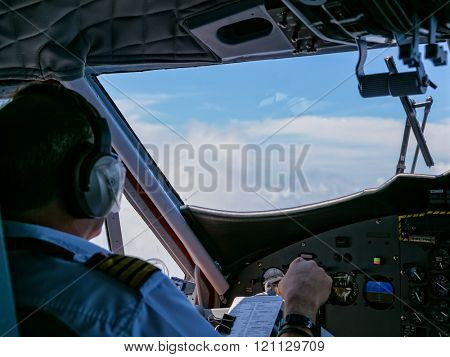 Rear view of pilot and copilot in cockpit