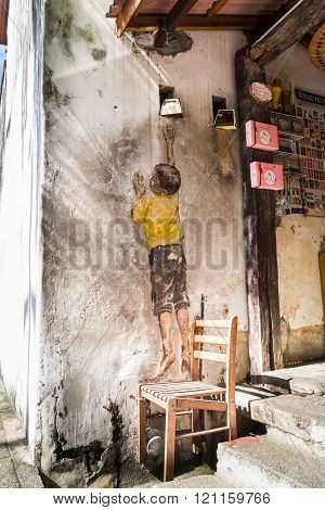 PENANG, DECEMBER 16, 2015:  Mural artwork by artist Ernest Zacharevic entitled Boy On Chair. The mur