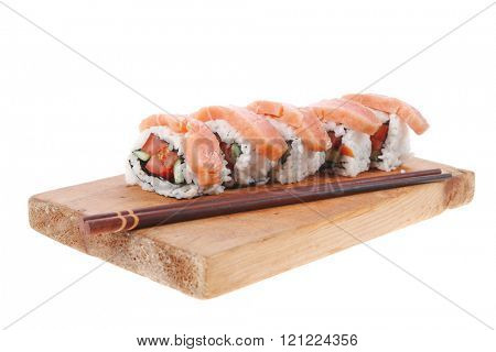 classic onigiri inside out californian sushi rolls with salmon on wooden plate isolated over white background with sticks