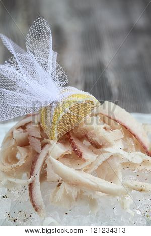 Stroganina- sliced raw frozen fish with  ice, wooden background.