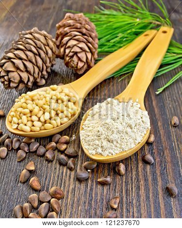 Flour and nuts cedar in spoon on board