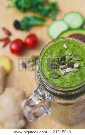 Healthy Green Juice Smoothie In A Bpa Free Plastic Jug Surrounded By Fresh Ginger, Avocado, Tomatoes