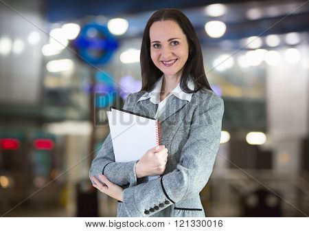 Successful business woman smiling portrait with note pad.