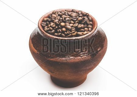 Grains of coffee in a decorative pot