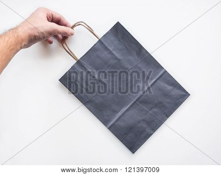 Mockup of paper shopping bag in hand
