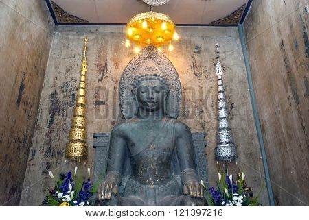 AYUTTHAYA,THAILAND-FEBRUARY10,2010 : Phra Khan Thavarat an approximately 5.20 meters high statue made of dark green stone,which from the Dvaravati comes period, Wat Na Phra Meru,Ayutthaya Historical Park of Thailand.