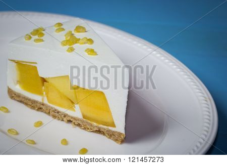 Close Up Of Mango Cream Pie With Peeled Split Mung Bean On White Plate And Blue Wood ,vintage Toning