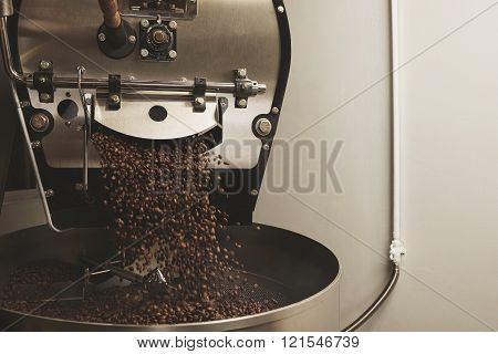 Coffee Beans Fall From A Large Roaster Machine