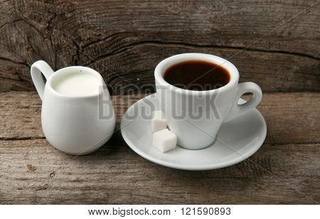 Cup of coffee espresso with with milk closeup on wooden background top view. Coffee background