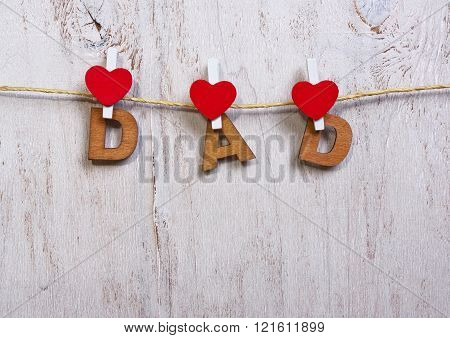 Wood Letters And Heart Forming Phrase Dad