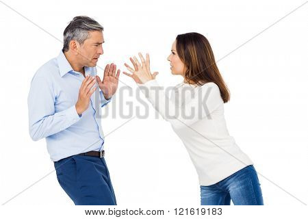 Annoyed woman yelling at husband against white background