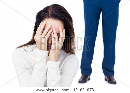 Angry couple ignoring each other against white background