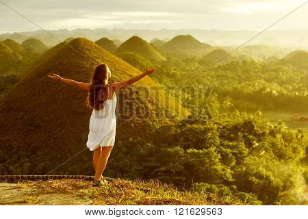 woman doing yoga in The Chocolate Hills. Bohol Philippines
