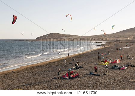 tenerife, spain, 1 january 2016: kite surfers and colorful sails on the beach of playa el médano in South Tenerife near punta del médano