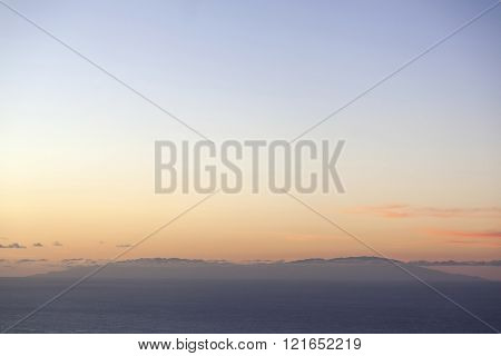 sunset over ocean behind sihouette of canarian island la palma seen from tenerife