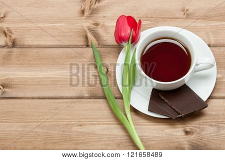 Tea Cup, Tulip Flower, Chocolate. Wooden Table. Top View. Copy S