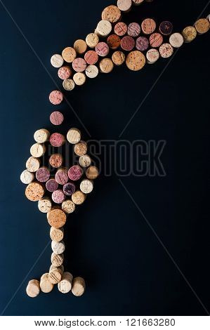 Filling a glass of wine from the bottle made by cork vertical