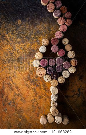 Glass of wine made by cork on the colorful background
