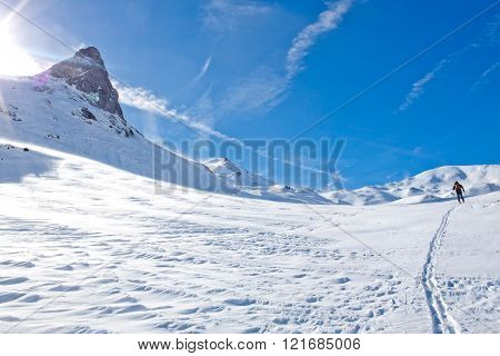 skier going up of a mountainin a sunny day