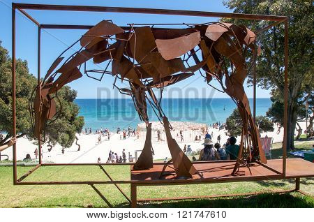 COTTESLOE,WA,AUSTRALIA-MARCH 12,2016: Metal horse sculpture overlooking Cottesloe Beach with tourists at the 