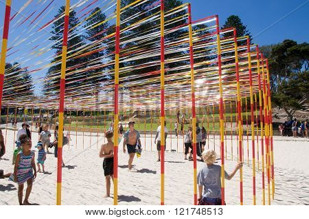 COTTESLOE,WA,AUSTRALIA-MARCH 12,2016:  Families with the pole and ribbon sculpture at the interactive free public arts festival 