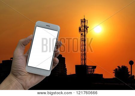 Large antenna with the sunset, holding a smart phone