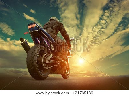 Man seat on the motorcycle under sky with clouds