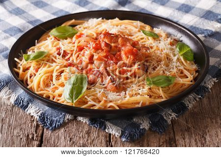 Italian food: pasta with Amatriciana Sauce and basil close-up