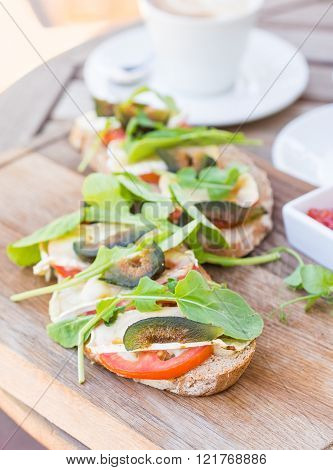 Grilled camambert and green figs with rocket and tomato on sour dough bread.