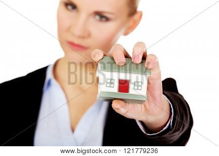 Aggresive business woman crushing small house