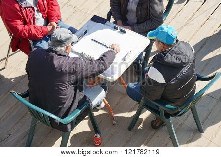 old men playing a game of domino