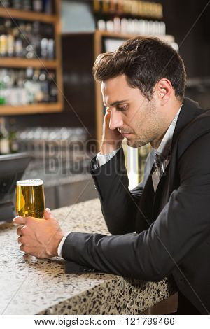 Tired man having a beer in a pub