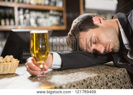 Tired man having a beer in a pub