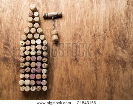 Wine corks in the shape of wine bottle on the wooden background.