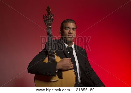 fado musician with a portuguese guitar, studio