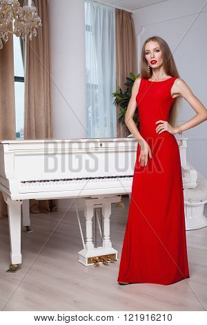 Beautiful blonde woman in red evening dress