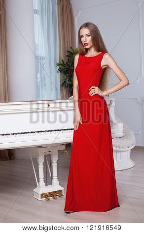 Beautiful blonde woman in red evening dress