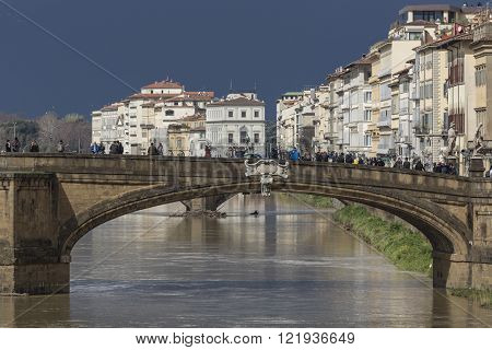 FLORENCE ITALY - MARCH 07: Ponte Santa Trinita bridge over the Arno River shown on March 07 2016 in Florence Italy. The Ponte Santa Trinita is the oldest elliptic arch bridge in the world