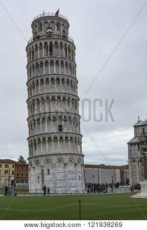 Piza, Italy - 10 March, 2016: View Of Leaning Tower And The Basilica, Piazza Dei Miracoli, Pisa, Ita