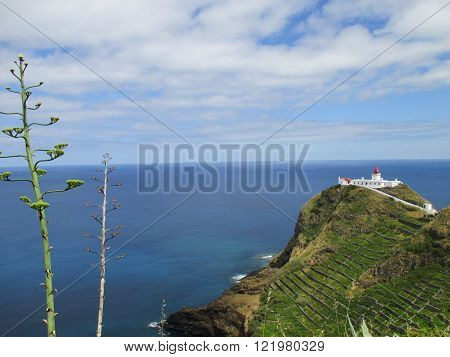 white lighthouse on the top of the cliff