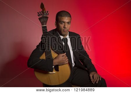 fado musician with a portuguese guitar, studio