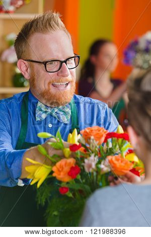 Helpful man selling arrangement in a busy flower shop
** Note: Shallow depth of field
