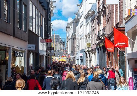 AMSTERDAM-APRIL 30: Crowd of people on Kalverstraat shopping street on April 30 2015 the Netherlands. The Kalverstraat is a busy shopping street of Amsterdam the capital of the Netherlands.