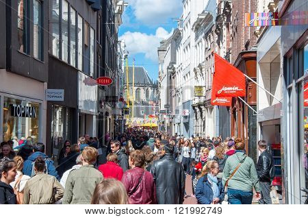 AMSTERDAM-APRIL 30: People on Kalverstraat shopping street on April 30 2015 the Netherlands. The Kalverstraat is a busy shopping street of Amsterdam the capital of the Netherlands.