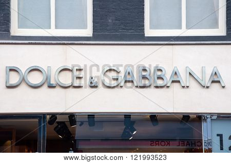 AMSTERDAM-APRIL 30: Dolce & Gabbana signboard on P.C.Hooftstraat shopping street on April 302015. The Italian fashion house was founded in 1985 by Italian designers